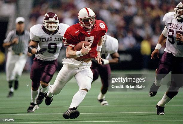 Quarterback Scott Frost of the Nebraska Cornhuskers moves the ball during a game against the Texas A&M Aggies at the Alamodome in San Antonio, Texas....