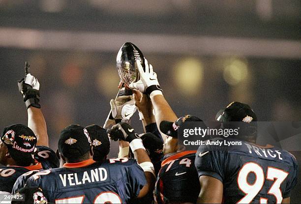 The Denver Broncos hold up the Lombardi Trophy after defeating the Green Bay Packers in Super Bowl XXXII at Qualcomm Stadium in San Diego,...