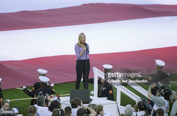 Singer Jewel sings the National Anthem before the start of Super Bowl XXXII between the Denver Broncos and Green Bay Packers at Qualcomm Stadium in...