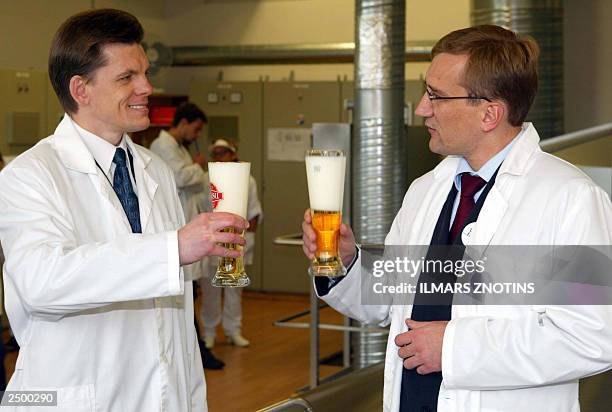 Einars Repse, Latvian Prime Minister and his Estonian counterpart Juhan Parts are raising a toast with a beer during the opening ceremony of Latvian...