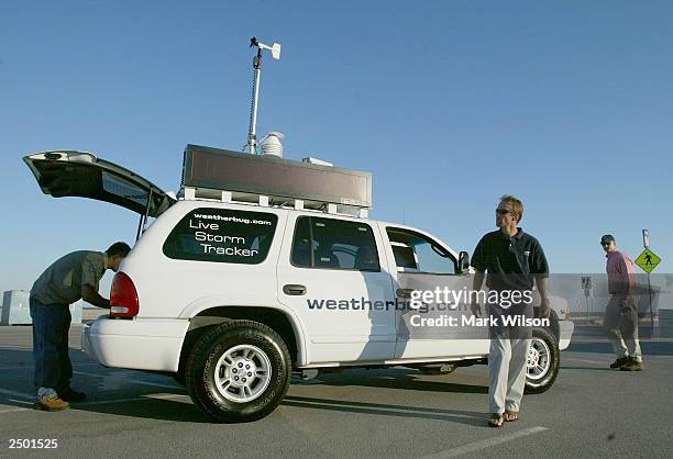 Donnie Reed, Richard Reed, and Jan Dutton of WeatherBug.com, work out of their vehicle while tracking and giving updates on Hurricane Isabel...