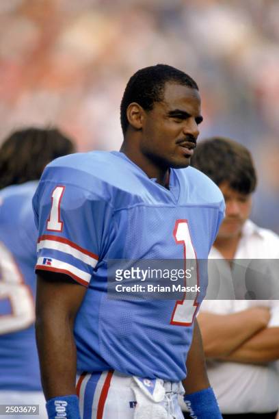 Quarterback Warren Moon of the Houston Oilers looks on during an NFL game against the Cleveland Browns at Cleveland Stadium on October 29, 1989 in...