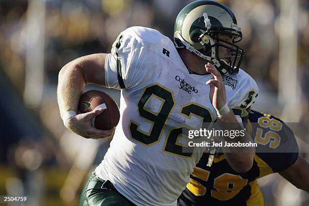 Tight end Matt Bartz of the Colorado State University Rams carries the ball against past linebacker Brian Tremblay of the University of California at...