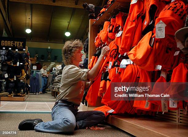 Employee Gail Hippert places hunting gear on the shelves at Cabela's September 17, 2003 in Hamburg, Pennsylvania. Cabela's 250,000 square foot first...