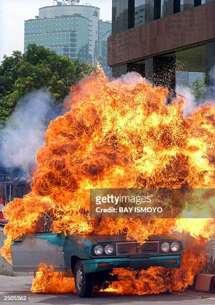 Car is blown up in the Sudirman Commercial Business District during a terrorism security drill in Jakarta, 15 September 2003. The business district...