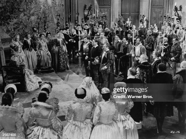 Australian born actor Errol Flynn stands before the queen in a scene from the film, The Sea Hawk, directed by Michael Curtiz, 1940.