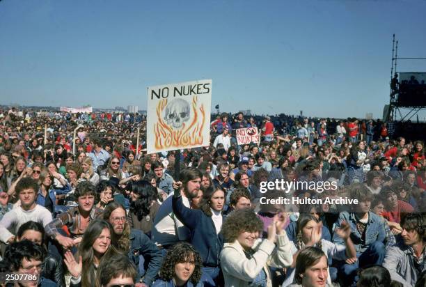 People hold up signs creading, "No Nukes," at an anti-nuclear demonstration in New York City, New York, 1982.