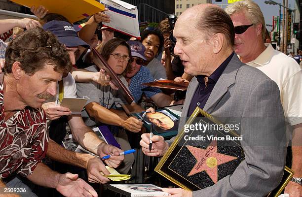 Actor Robert Duvall signs autographs after a ceremony honoring him with a star on the Hollywood Walk of Fame on September 18, 2003 in Hollywood,...