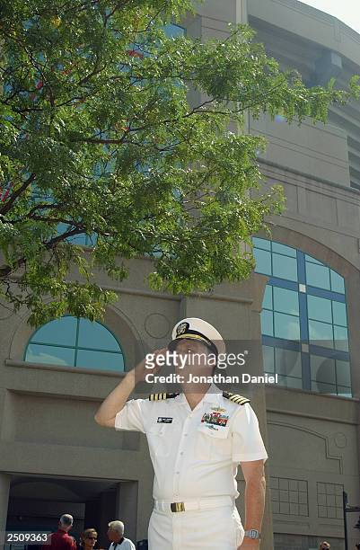 Navy Captain David Johnson, who works at the Pentagon and was there the morning of the terrorist attacks on September 11 salutes a flag that flew...