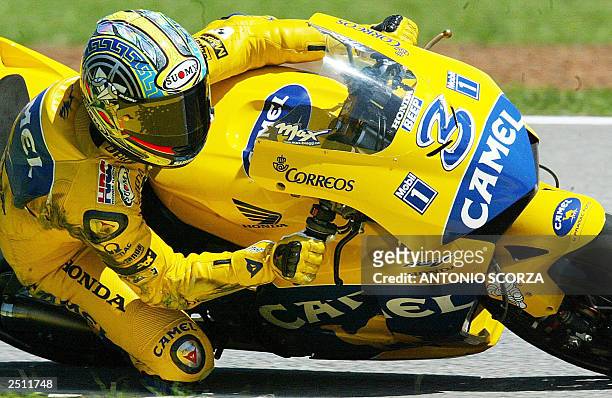 Italian MotoGP rider Maximiliano Biaggi negotiates a turn on his Honda Pons, 19 September 2003, during the second training session at the Nelson...