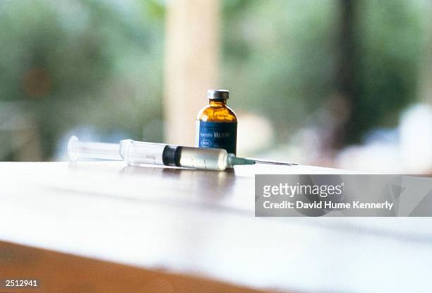 Needle and syringe lie near a vial of valium November 18, 1978 after over 900 members of the People's Temple Cult led by Reverend Jim Jones committed...