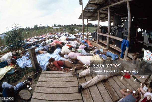 The Reverend Jim Jones' bloated body lies on the ground along with his followers after it was hastily sewn together after his autopsy by officials at...