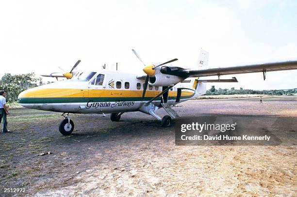 The airplane which carried California Congressman Leo Ryan sits on a runway November 18, 1978 in Port Kaituma, Guyana after he was shot and killed by...