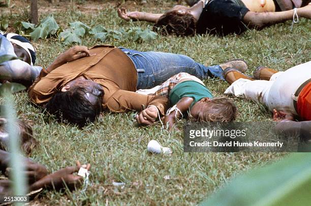 The bodies of a mother and child lie among the dead near the compound of the People's Temple cult November 18, 1978 in Jonestown, Guyana after over...