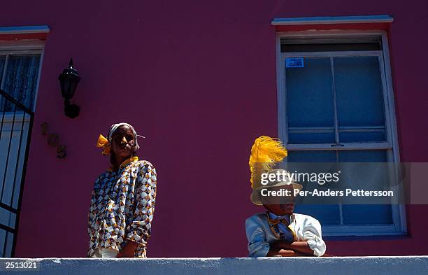 Unidentified participants take a break January 2, 2003 during the yearly "Coon Carnival" in Bo-Kaap, a Muslim area of Cape Town, South Africa. The...