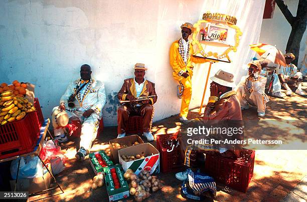 Unidentified participants take a break January 2, 2003 during the yearly "Coon Carnival" in Bo-Kaap, a Muslim area of Cape Town, South Africa. The...
