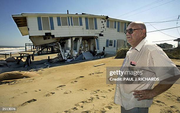 Arthur Glidden looks out at the the Atlantic Ocean near a home damaged by Hurricane Isabel 19 September in Kitty Hawk, North Carolina. Isabel left at...