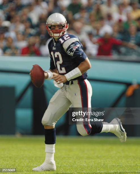 Quarterback Tom Brady of the New England Patriots rolls out to pass during the NFL game against the Philadelphia Eagles on September 14, 2003 at...