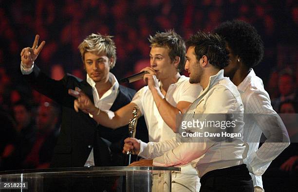 British pop stars Antony Costa , Duncan James , Simon Webbe and Lee Ryan of the boy band "Blue" win the award for "Best Pop Act" at the 2003 Brit...