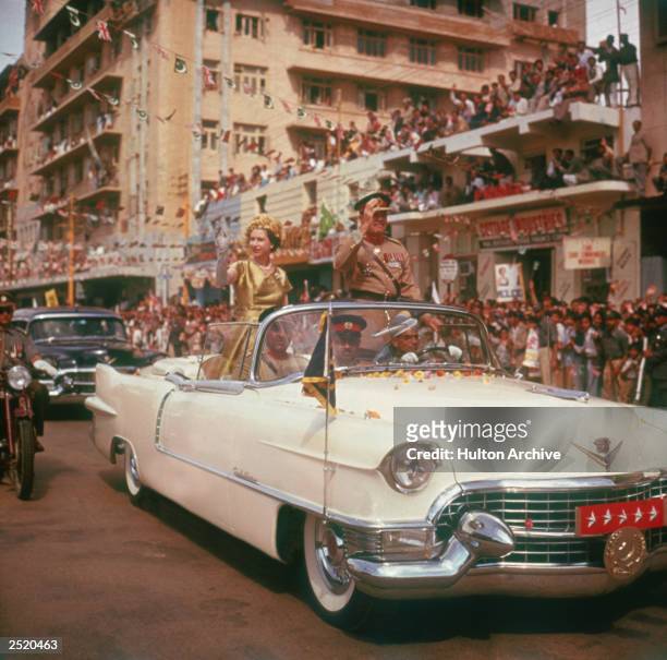Queen Elizabeth II is driven through the streets of Karachi during the second phase of her tour of Pakistan, 1st February 1961.