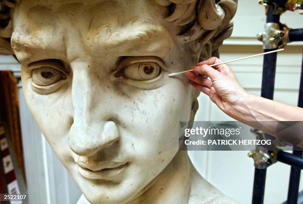 Italian restorer Cinzia Parnigoni works on cleaning one of the world's most famous statues, Michelangelo's David, 15 September 2003 at the Galleria...