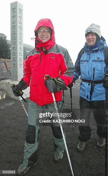 Hartwig Gauder , former German Olympic champion, and a supporter arrive at the top of the summit of Mt. Fuji 776-metre , 19 July 2003. Gauder is on a...