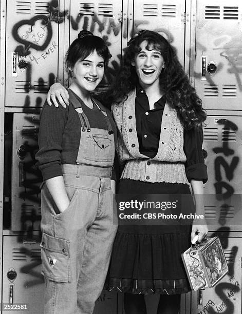 Promotional protrait of Amy Linker and Sarah Jessica Parker in front of graffitti covered high school lockers for the television series, 'Square...