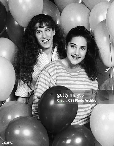 Promotional protrait of Amy Linker and Sarah Jessica Parker amidst balloons for the television series, "Square Pegs," 1982.