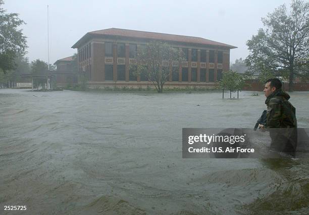 In this handout image, Staff Sergeant Jason Smith from the 1st Communications Squadron braves the water and wind of Hurricane Isabel to document...