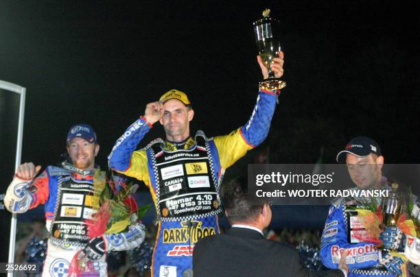 Poland's Tomasz Gollob , who won the event, Australian second placed Jason Crump and third placed Nicki Pedersen, display their trophies on the...