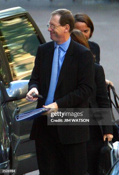 British Prime minister Tony Blair's official spokesman Tom Kelly arrives , 23 September 2003 at the Royal courts of justice to testify before the...