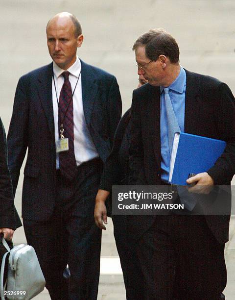 British Prime minister Tony Blair's official spokesmen Tom Kelly and Godric Smith arrive, 23 September 2003 at the Royal courts of justice to testify...