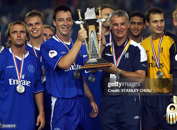 Chelsea footballers celebrate with the Asia Cup Trophy after their win over Newcastle United at the Bukit Jalil National Stadium in Kuala Lumpur,...