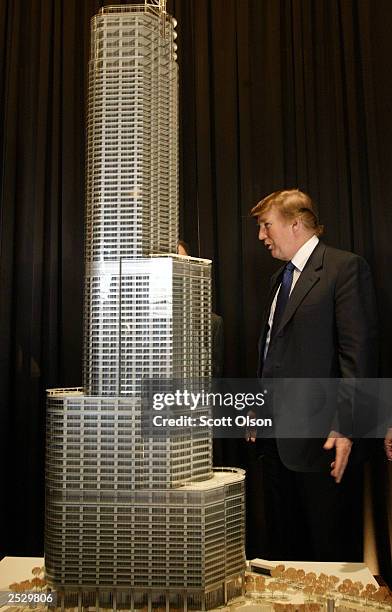 Real estate developer Donald Trump stands next to a model of Trump Tower Chicago at a news conference September 23, 2003 Chicago, Illinois. The...