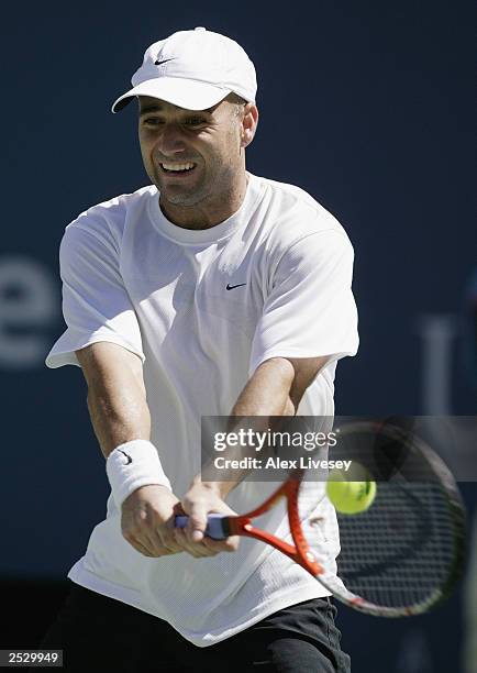 Andre Agassi returns a shot to Juan Carlos Ferrero of Spain during the US Open men's singles semi-finals at the USTA National Tennis Center in...