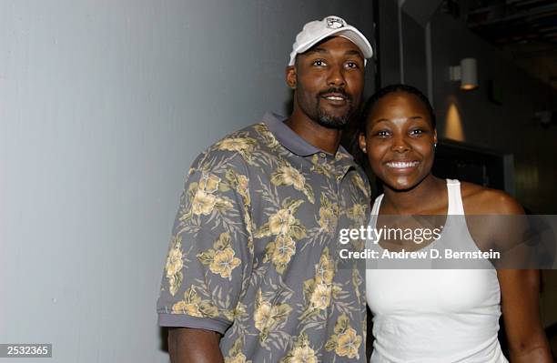 Karl Malone of the Los Angeles Lakers and daughter Cheryl Ford of the Detroit Shock pose after Game one of the 2003 WNBA Finals against the Los...