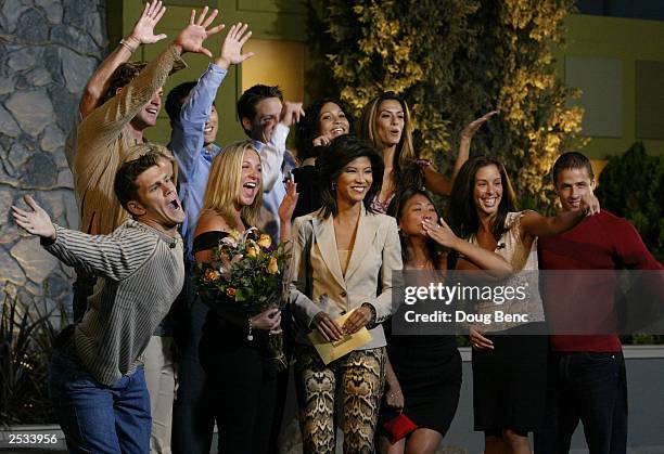 Host Julie Chen is surrounded by cast members after the season finale of Big Brother 4 on September 24, 2003 at the CBS Studio Center/Ratford Lot in...