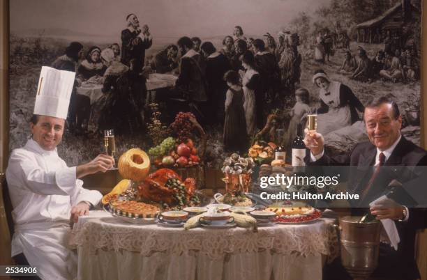 Restaurateur Sirio Maccioni and chef Daniel Boulud toast each other over a lavish spread at Maccioni's Le Cirque Restaurant, New York, 1990.