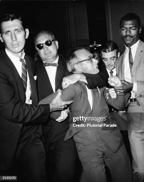 American Civil Liberties lawyer, Arthur Kinoy , is pulled from the House of Un-American Activities Committee hearing room in Washington, D.C. August...