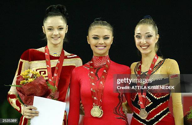 Medalists of ribbon category, second placed Ukrainian Anna Bessonova, winner Russian Alina Kabaeva and bronze medalist Bulgarian Elizabeth Paysieva...