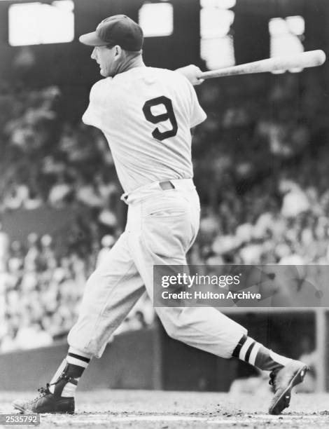 Boston Red Sox player Ted Williams swings at the plate during a game, circa 1940.