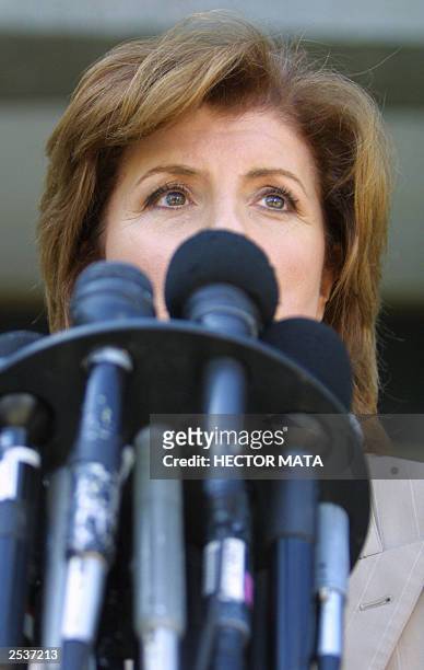 Political comentator Arianna Huffington talks with reporters as she arrives to the Los Angeles County Registar Office in Norwalk, CA to register her...