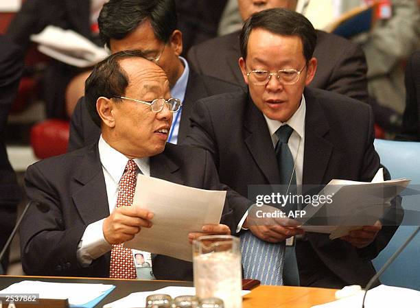 Chinese Foreign Minister Li Zhaoxing talks with an aide prior to a United Nations Security Council meeting 24 September, 2003. The Security Council...