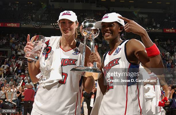 Ruth Riley and Swin Cash of the Detroit Shock celebrate after defeating the Los Angeles Sparks in Game three of the 2003 WNBA Finals on September 16,...