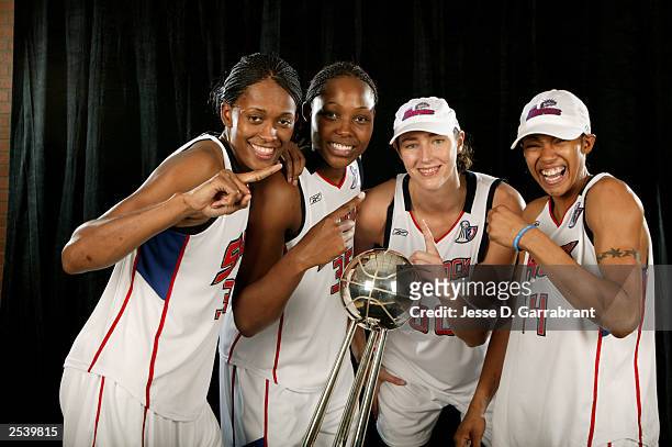 Swin Cash, Cheryl Ford 35, Ruth Riley, and Deanna Nolan of the Detroit Shock celebrate with the 2003 WNBA Championship trophy after the Shock...