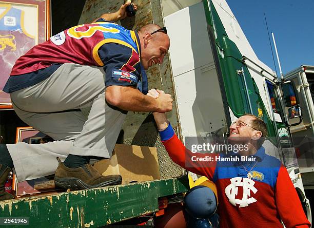 Martin Pike for Brisbane is congratulated by former Lion great and Brownlow Medallist Kevin Murray during an after match function at Brunswick St...