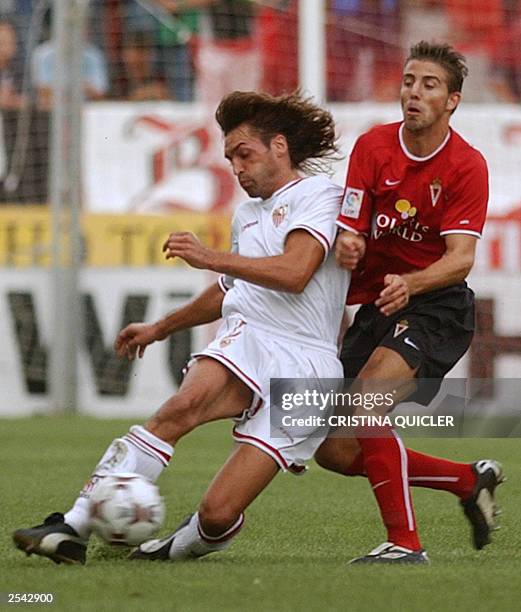 Seville's player Javi Navarro fights for the ball with Real Murcia's player Luis Garcia during a spanish soccer league match at Sanchez Pizjuan...