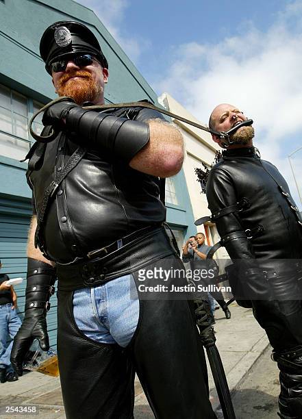 Man who did not want to be identified by name pulls his slave "Ricky" at the 20th Annual Folsom Street Fair September 28, 2003 in San Francisco,...