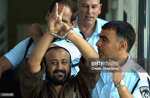 Palestinian leader Marwan Barghouti is taken away under escort September 29, 2003 in Tel Aviv, Israel after continued proceedings in his trial in the...