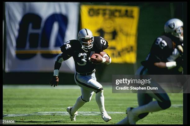 Running back Bo Jackson of the Los Angeles Raiders runs down the field during a game against the San Diego Chargers at the Los Angeles Coliseum in...